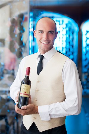 Waiter holding bottle of wine in restaurant Stock Photo - Premium Royalty-Free, Code: 6113-06626550