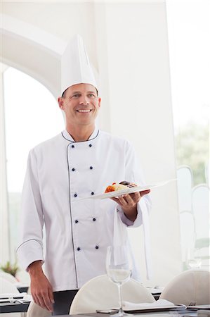 Chef holding plate of food in restaurant Stock Photo - Premium Royalty-Free, Code: 6113-06626577