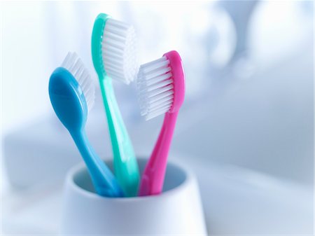 Close up of toothbrushes in holder Stock Photo - Premium Royalty-Free, Code: 6113-06626652