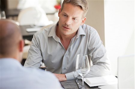 Businessmen talking in restaurant Stock Photo - Premium Royalty-Free, Code: 6113-06626608