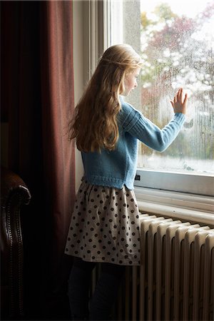 female on a radiator - Girl looking out window Stock Photo - Premium Royalty-Free, Code: 6113-06626745