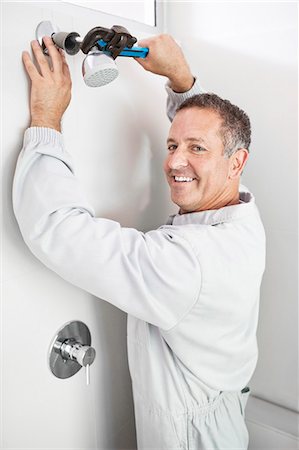 plumber - Plumber working on shower head in bathroom Stock Photo - Premium Royalty-Free, Code: 6113-06753233