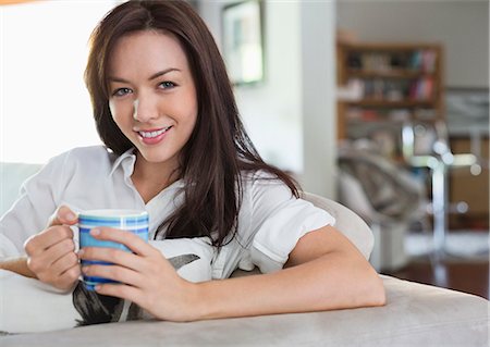 Smiling woman drinking cup of coffee Stock Photo - Premium Royalty-Free, Code: 6113-06753327
