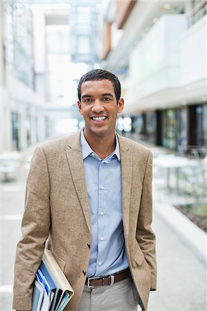 Businessman smiling on city street Stock Photo - Premium Royalty-Free, Code: 6113-06753448