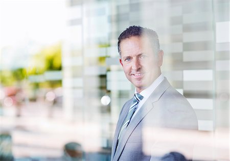 Businessman smiling in office Stock Photo - Premium Royalty-Free, Code: 6113-06753412