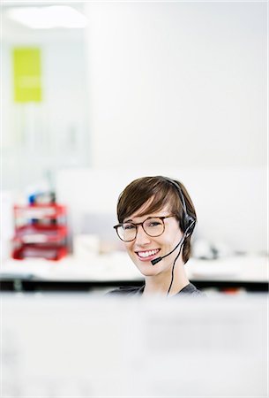 Businesswoman wearing headset in office Stock Photo - Premium Royalty-Free, Code: 6113-06753424
