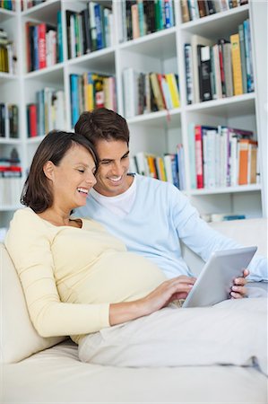 simsearch:6113-06753677,k - Couple using tablet computer on sofa Stock Photo - Premium Royalty-Free, Code: 6113-06753652