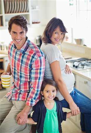 simsearch:6113-06909372,k - Family smiling together in kitchen Stock Photo - Premium Royalty-Free, Code: 6113-06753672