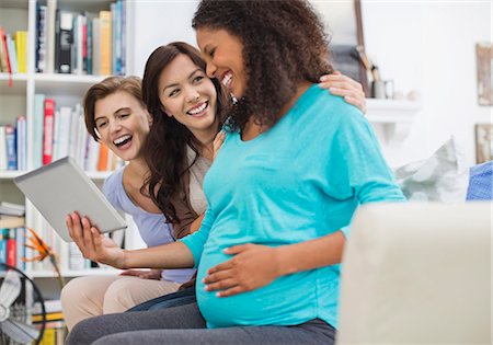 simsearch:6113-06753677,k - Pregnant woman using tablet computer with friends Stock Photo - Premium Royalty-Free, Code: 6113-06753600
