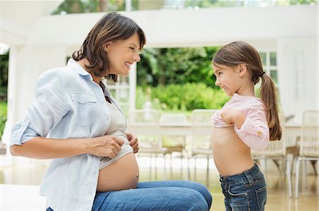 female midriff images - Girl and pregnant mother comparing bellies Stock Photo - Premium Royalty-Free, Code: 6113-06753702