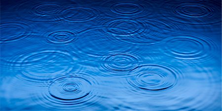 Ripples of raindrops in puddle Stock Photo - Premium Royalty-Free, Code: 6113-06753880