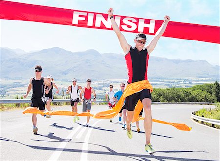 people at cross roads - Runner crossing race finish line Stock Photo - Premium Royalty-Free, Code: 6113-06753987