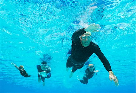 swimming men athletes - Triathletes in wetsuits underwater Stock Photo - Premium Royalty-Free, Code: 6113-06754059