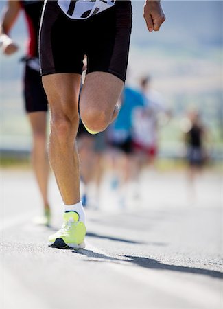 running a marathon - Runner in race on rural road Stock Photo - Premium Royalty-Free, Code: 6113-06754065