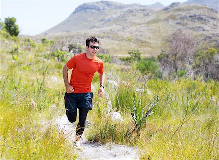 Man running on dirt path Stock Photo - Premium Royalty-Free, Code: 6113-06754174