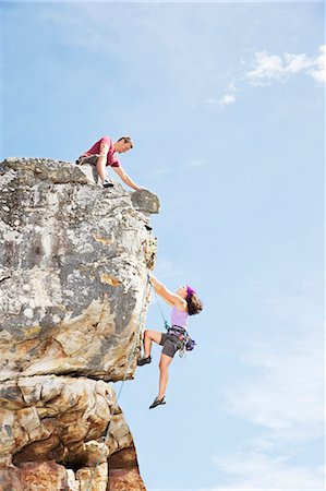 dangling - Climbers scaling steep rock face Stock Photo - Premium Royalty-Free, Code: 6113-06754130