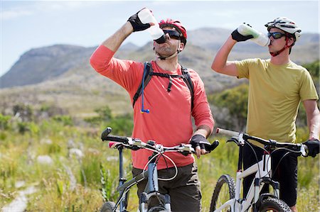 mountain bikers driving water in rural landscape Stock Photo - Premium Royalty-Free, Code: 6113-06754137