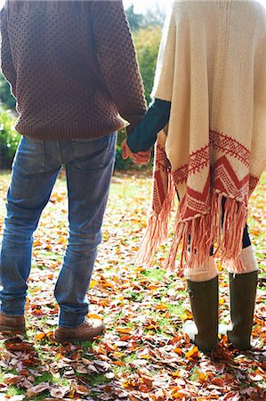 poncho - Couple holding hands in autumn leaves Stock Photo - Premium Royalty-Free, Code: 6113-06720240