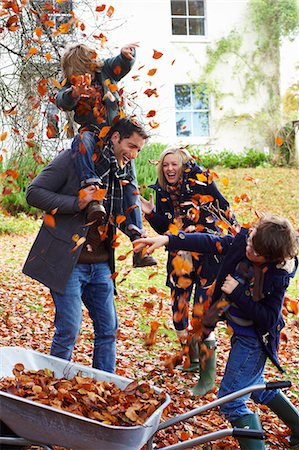 family  fun  outside - Family playing in autumn leaves Stock Photo - Premium Royalty-Free, Code: 6113-06720267