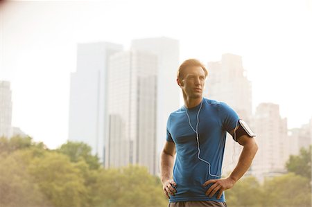 Runner standing in urban park Stock Photo - Premium Royalty-Free, Code: 6113-06720346