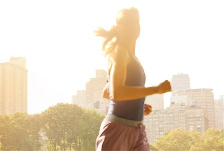 Woman running in urban park Stock Photo - Premium Royalty-Free, Code: 6113-06720327