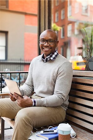 pictures of bald men in glasses - Man using tablet computer on city street Stock Photo - Premium Royalty-Free, Code: 6113-06720449