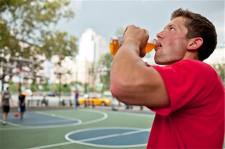 fitness man exhausting - Man having sports drink court Stock Photo - Premium Royalty-Free, Code: 6113-06720405