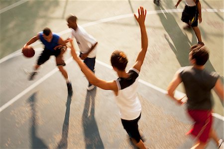 Men playing basketball on court Stock Photo - Premium Royalty-Free, Code: 6113-06720414