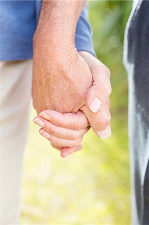 Older couple holding hands outdoors Stock Photo - Premium Royalty-Free, Code: 6113-06720584