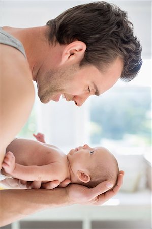 simsearch:6113-06720629,k - Father cradling newborn baby Foto de stock - Sin royalties Premium, Código: 6113-06720642