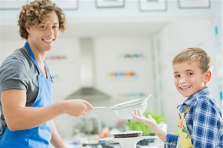 parent child messy cooking - Father and son baking in kitchen Stock Photo - Premium Royalty-Free, Code: 6113-06720690