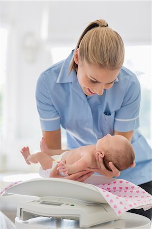 simsearch:6113-06720629,k - Nurse weighing newborn baby Foto de stock - Sin royalties Premium, Código: 6113-06720629