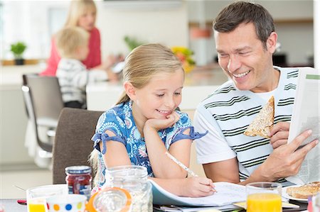 father son laughing - Father and daughter having breakfast Stock Photo - Premium Royalty-Free, Code: 6113-06720704