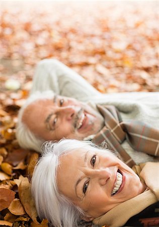 senior adult relaxing portrait not child - Older couple laying in autumn leaves Stock Photo - Premium Royalty-Free, Code: 6113-06721253