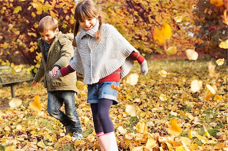 fall leaves - Children playing in autumn leaves Stock Photo - Premium Royalty-Free, Code: 6113-06721293