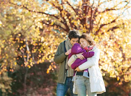 Couple cradling baby in park Stock Photo - Premium Royalty-Free, Code: 6113-06721211