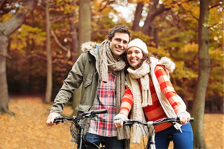 exercise outdoors autumn - Couple riding bicycles together in park Stock Photo - Premium Royalty-Free, Code: 6113-06721220