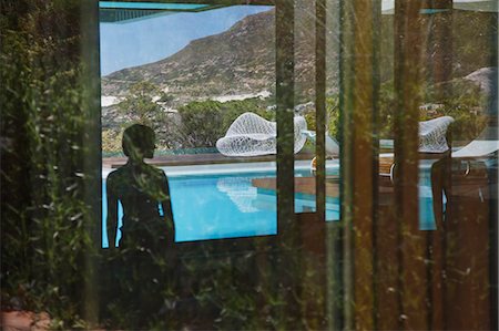 Shadow of woman looking at swimming pool Stock Photo - Premium Royalty-Free, Code: 6113-06898745