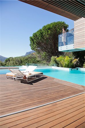 pool edge - Woman on balcony above swimming pool Stock Photo - Premium Royalty-Free, Code: 6113-06898768