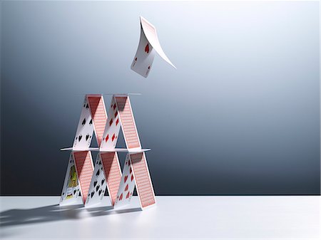 pyramid of playing cards - Cards jumping from house of cards Stock Photo - Premium Royalty-Free, Code: 6113-06898979