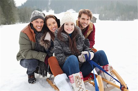 simsearch:6113-06899345,k - Portrait of happy friends on sled in snowy field Stock Photo - Premium Royalty-Free, Code: 6113-06899343