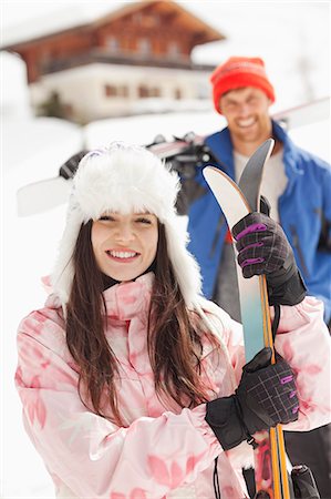 simsearch:6113-06899345,k - Portrait of smiling couple with skis outside cabin Stock Photo - Premium Royalty-Free, Code: 6113-06899361