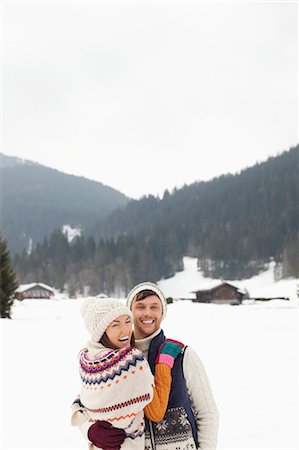 simsearch:6113-06899345,k - Portrait of happy couple hugging in snowy field Stock Photo - Premium Royalty-Free, Code: 6113-06899394