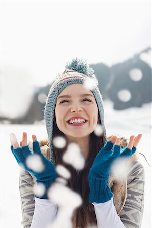 fingerless gloves - Happy woman watching snow fall Stock Photo - Premium Royalty-Free, Code: 6113-06899322