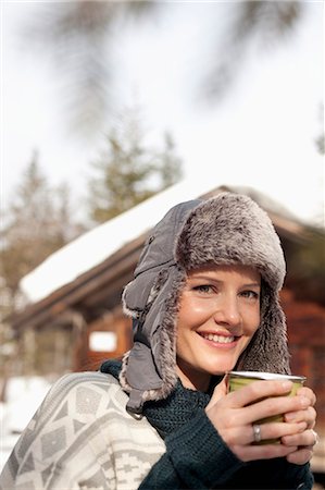 simsearch:6113-06899345,k - Close up portrait of woman in fur hat drinking coffee outside cabin Stock Photo - Premium Royalty-Free, Code: 6113-06899461