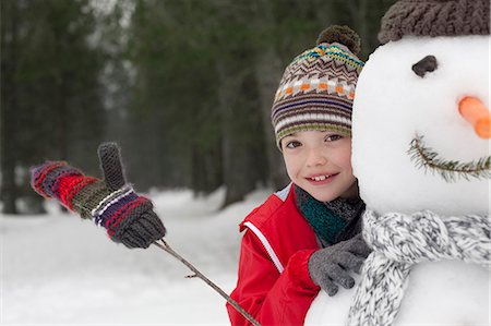 simsearch:6113-06899345,k - Close up of smiling boy behind snowman Stock Photo - Premium Royalty-Free, Code: 6113-06899476