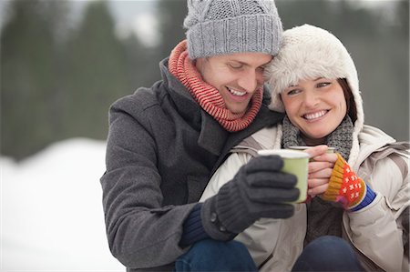 Happy couple drinking coffee in snow Stock Photo - Premium Royalty-Free, Code: 6113-06899482
