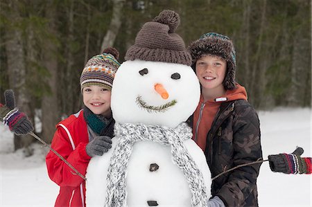 simsearch:6113-06899345,k - Portrait of happy boys posing with snowman Stock Photo - Premium Royalty-Free, Code: 6113-06899490