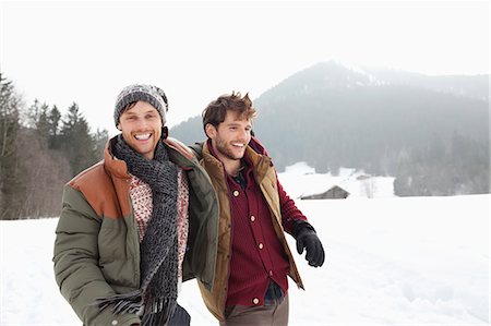 simsearch:6113-06899345,k - Portrait of happy men walking in snowy field Stock Photo - Premium Royalty-Free, Code: 6113-06899404