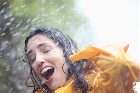 Rain falling on surprised woman Stock Photo - Premium Royalty-Free, Code: 6113-06899559